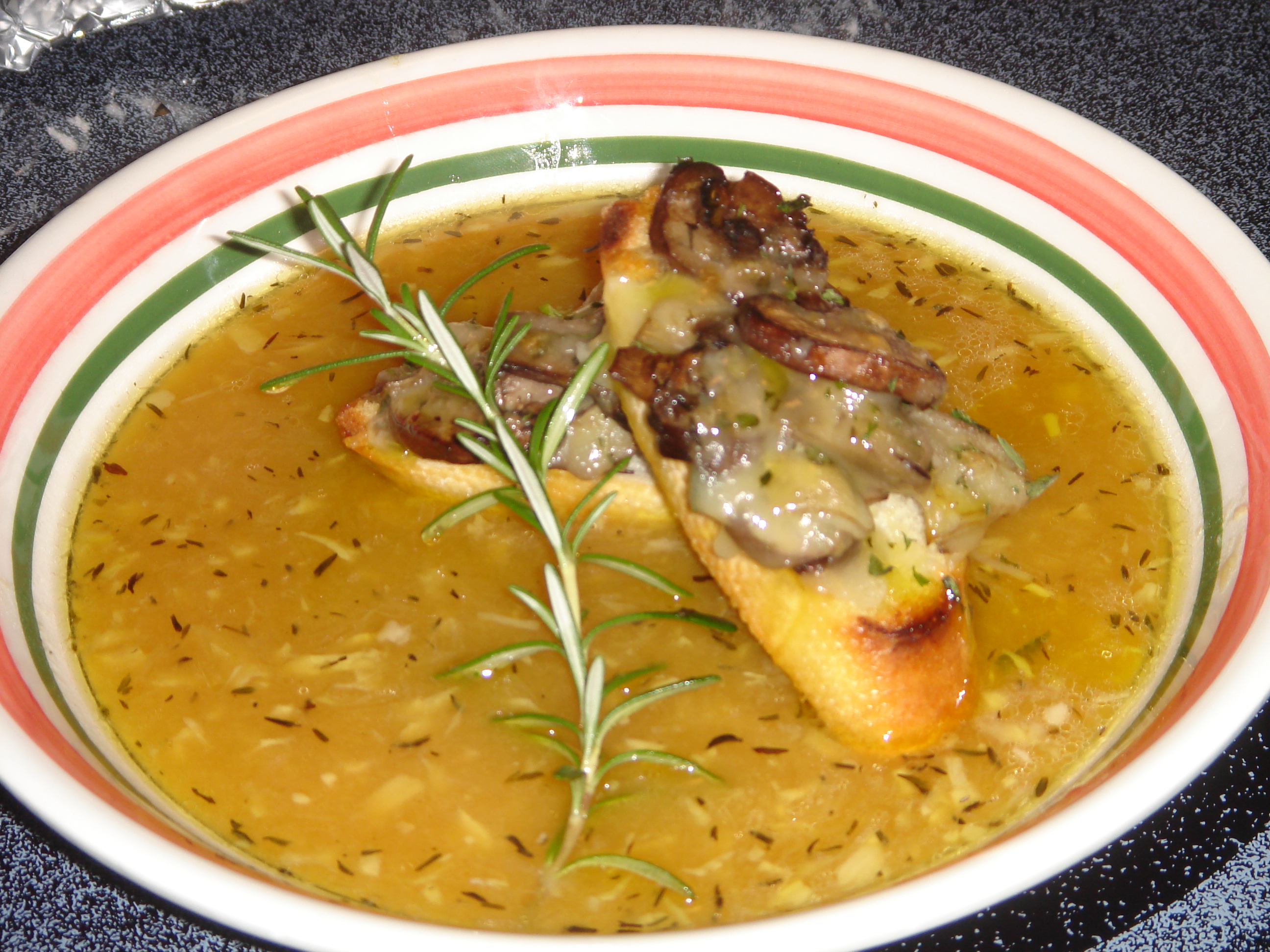 Roasted Garlic Soup Topped With Mushroom And Gruyère Cheese Crostinis