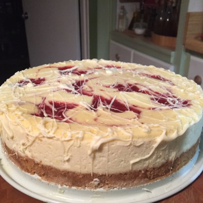 Strawberry Cheesecake Swirl Topped With A White Chocolate Drizzle